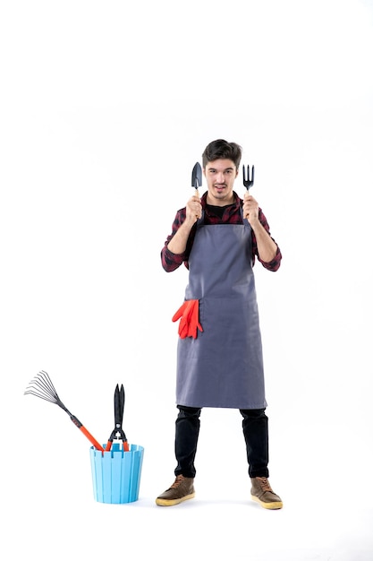 front view male gardener holding little spatulas on white background work green garden uniform soil tree flower job ground