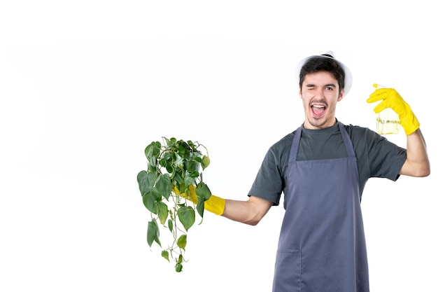 Front view male gardener holding plant in pot and spray on white background work tree grass bush color ground job garden flower