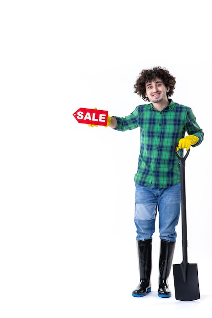 front view male gardener holding shovel and sale writing on white background grass flowers water field job tree garden cleaning ground