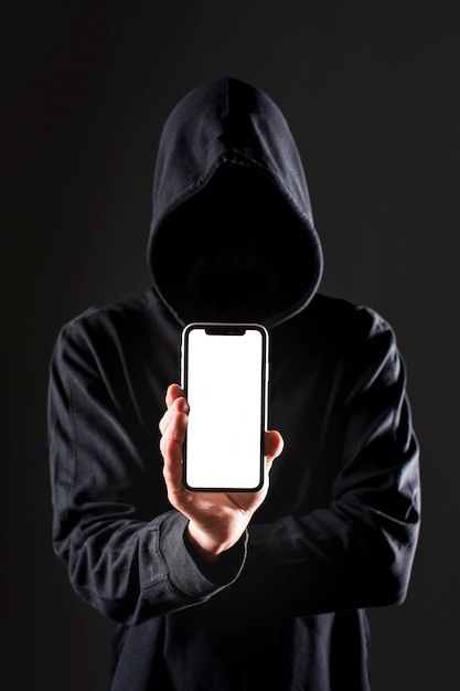 Photo front view of male hacker holding smartphone