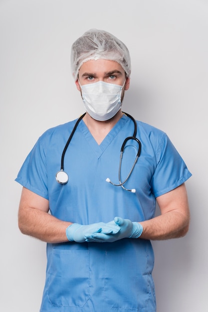 front view male nurse with mask and gloves