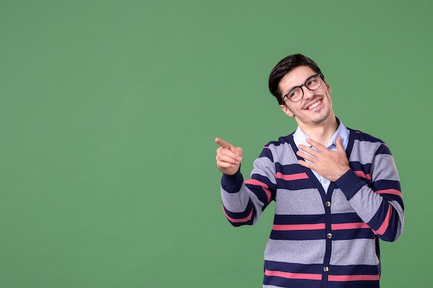 front view male teacher pointing at something on green background university student book woman lesson library color school