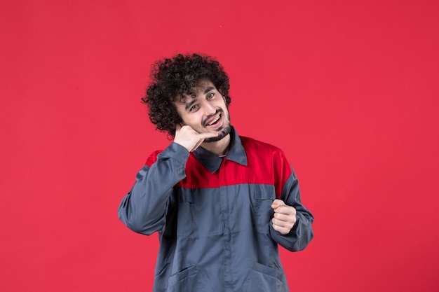 Front view male worker in uniform on red background mechanic photo house worker uniform tool instrument job colors