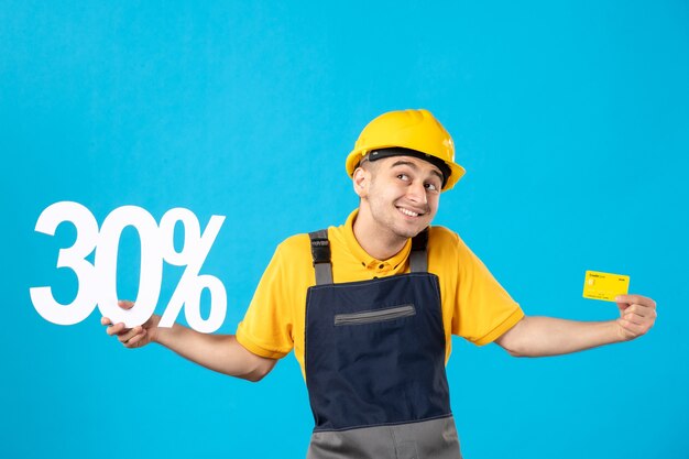 Front view male worker in uniform with writing and bank card blue 