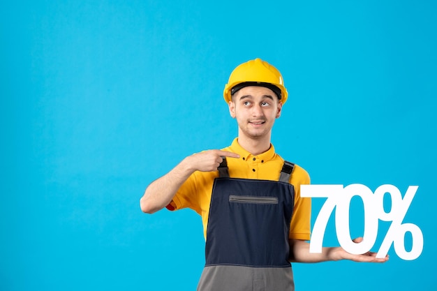 Front view of male worker in uniform with writing on blue 