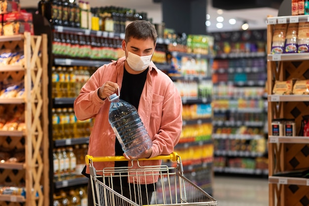 Front view man holding bottle