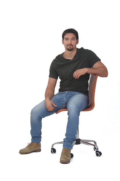 Front view of a man looking at camera and relaxed on white background