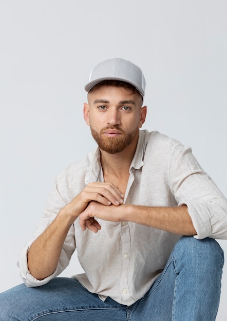 Front view man posing with trucker hat