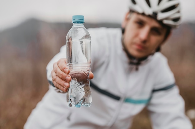 Photo front view man riding a mountain bike in special equipment