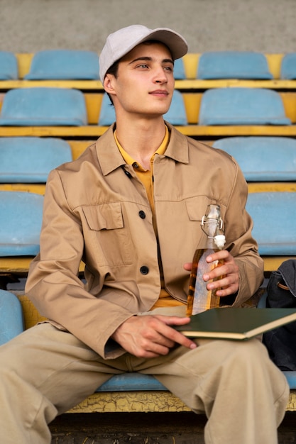 Front view man sitting in grandstands