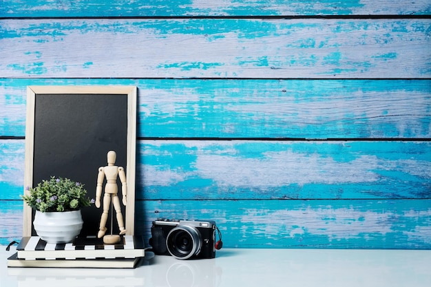 Photo front view of minimal workspace desk with supplies and wooden wall