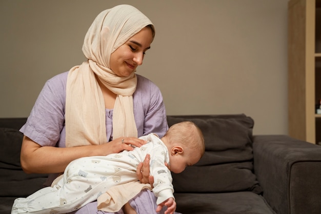 front view mother holding baby