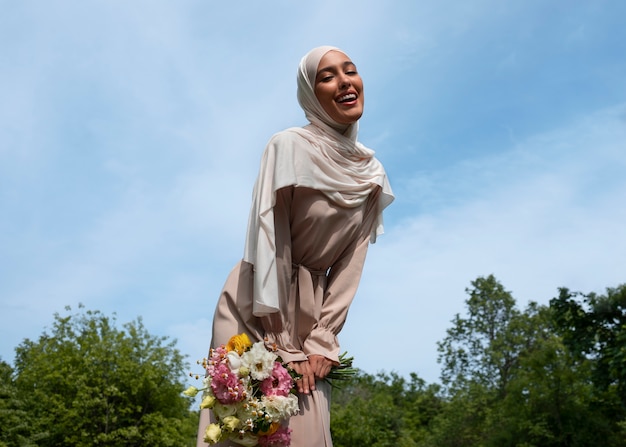 Front view muslim woman posing outdoors