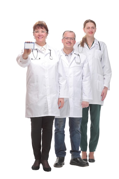 Front view of nurses and doctor showing a blank business card. Concept of medical help and confidence