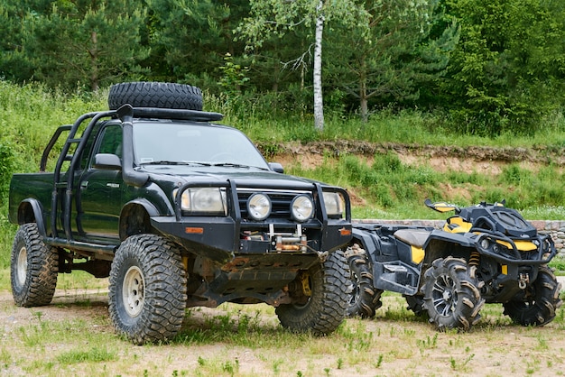 Front view of old car and quad bike