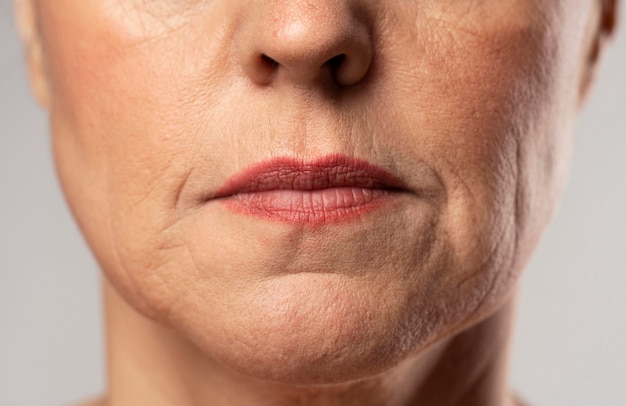 Front view of older woman posing stoic with make-up on