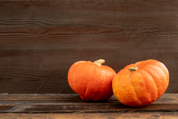 Front view orange pumpkins on wooden table