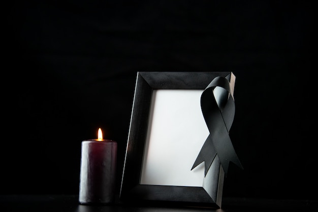 Front view of picture frame with black bow on dark