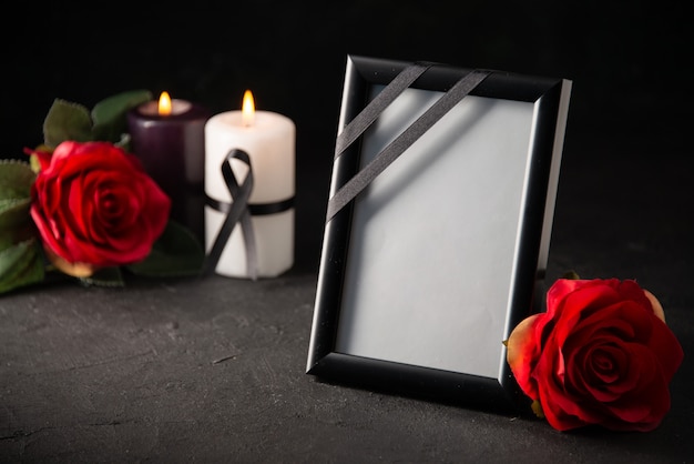 Front view of picture frame with candles on black