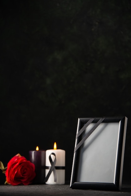 Front view of picture frame with candles on black