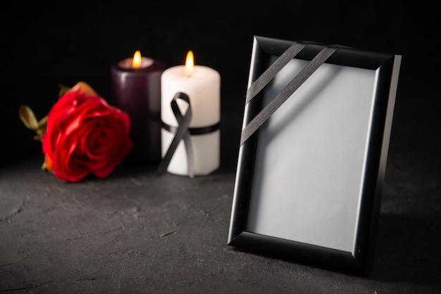 Front view of picture frame with candles on black