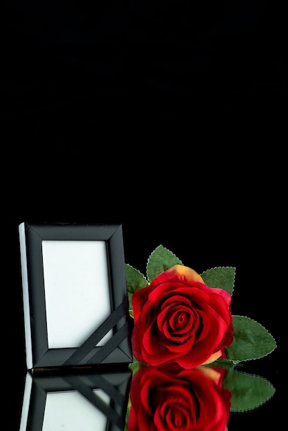 Front view of picture frame with red rose on black