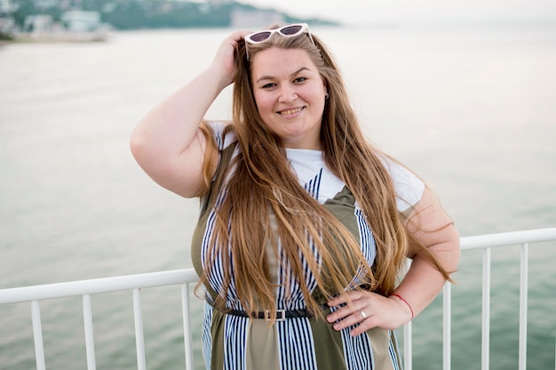 Front view plus size model next to the ocean