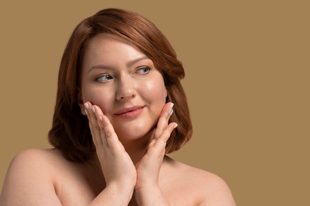 Photo front view plus size model posing in studio