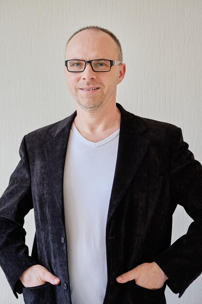 Front view portrait of a man in black jacket on a white background handsome man with glasses