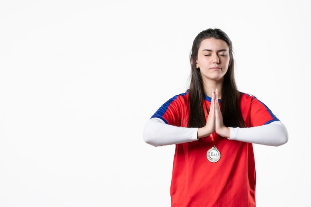 Front view praying female player with medal