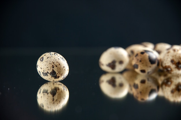 front view quail eggs on black background with copy place