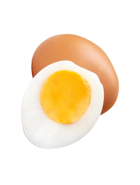 front view of raw brown chicken egg and cooked or boiled chicken egg with egg yolk in half
