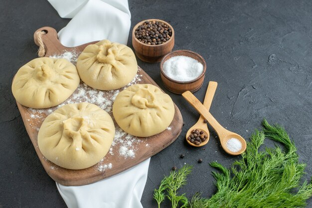 front view raw dumplings on cutting board on dark background cooking restaurant horizontal food dough dinner meat