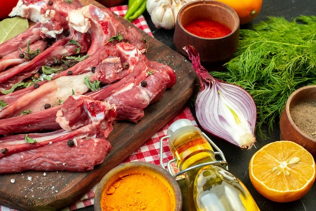 Vista frontale fette di carne cruda con verdure e verdure fresche su sfondo scuro pasto carne insalata cibo piatto da cucina