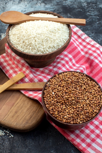 front view raw rice with orange lentils and buckwheat on dark background food seed cereal color meal groats soup