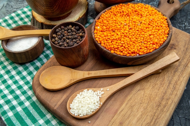 front view raw rice with orange lentils and buckwheat on dark background groats seed meal soup cereal food