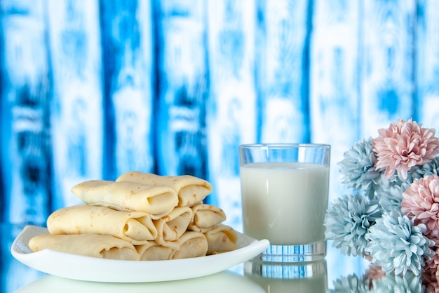 front view rolled sweet pancakes with glass of milk on a light background meal breakfast food sugar flower color cake morning