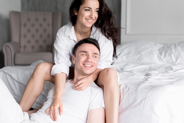 Front view of romantic smiley couple posing at home