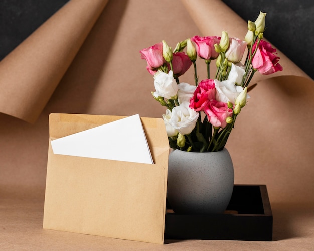 Front view roses in vase arrangement with envelope