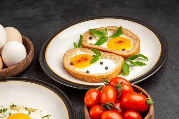 front view scrambled eggs with toasts and tomatoes on dark background bread omelette food breakfast lunch tea meal morning