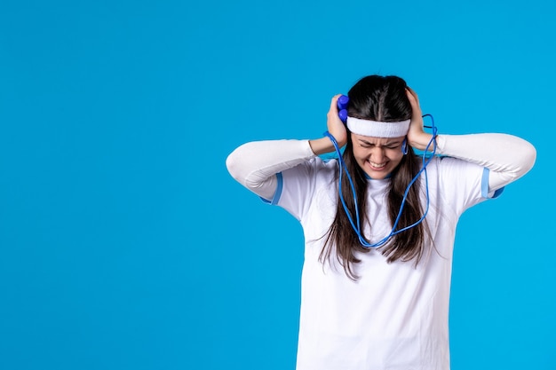 Front view screaming pretty female holding skipping rope