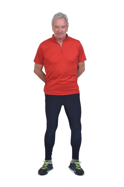 Front view of a senior man with sportswear hands on back on white background