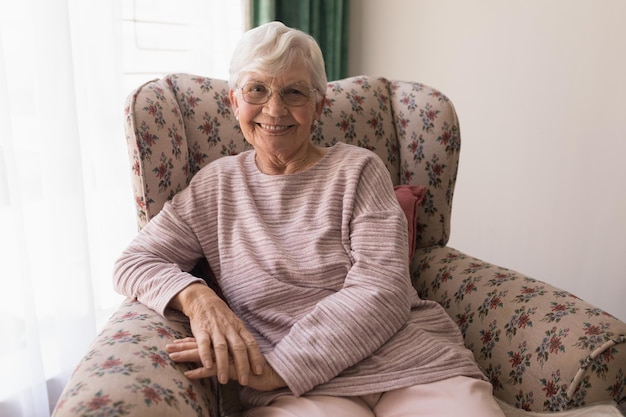 front view of senior woman looking at camera in home