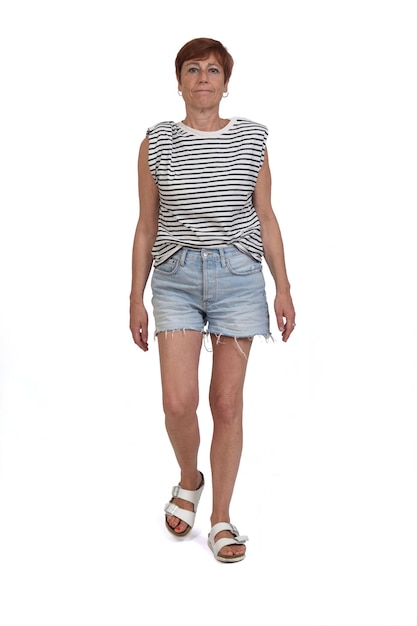 Front view serious woman with shorts walking on white background