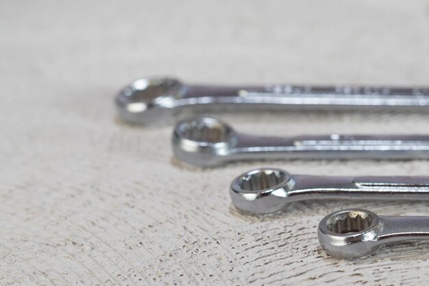 Photo front view of set of spanners and on concrete background with copy space