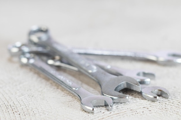 Front view of set of spanners and on concrete background