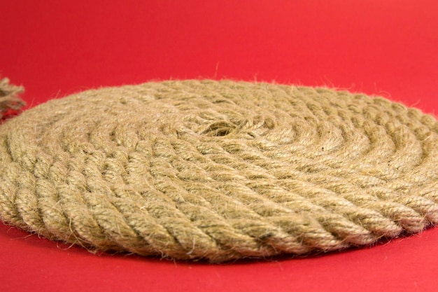 Front view shot with selected focus of Hemp rope on red background