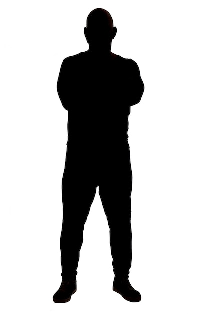 Photo front view of the silhouette of a man wearing casual clothes with his arms crossed