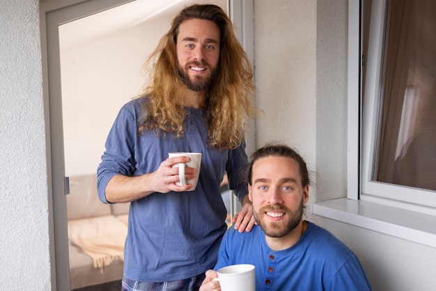 Front view smiley brothers with mugs