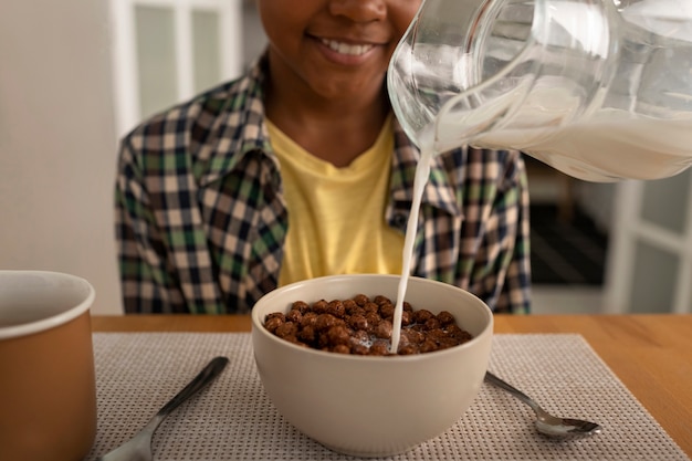 front view smiley kid at breakfast